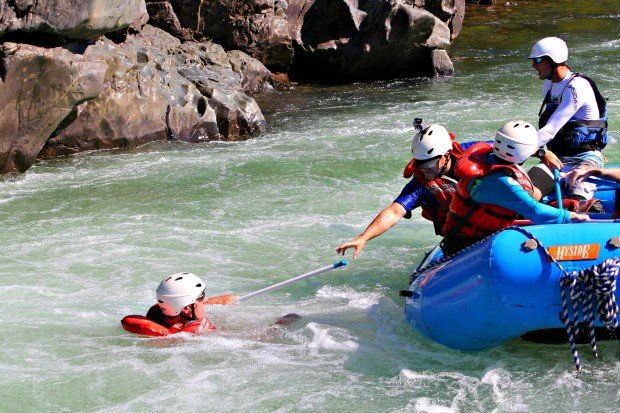 extending a paddle to a man overboard