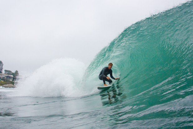A surfer catches a wave